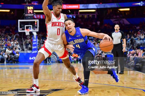 Jalen Suggs of the Orlando Magic dribbles against Jalen Green of the Houston Rockets in the second half at Amway Center on February 25, 2022 in...