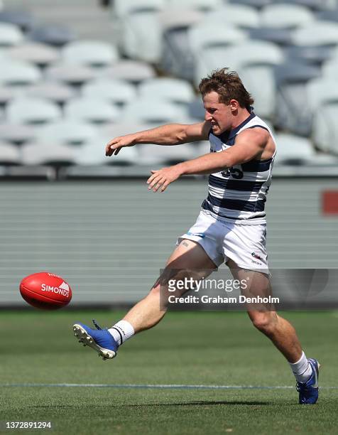 Jack Mentha of the Cats kicks during the AFL Practice Match between Geelong Cats and Richmond Tigers at GMHBA Stadium on February 26, 2022 in...