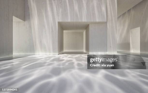 empty hall in a modern building with underwater ripple pattern - wasser strahl stock-fotos und bilder