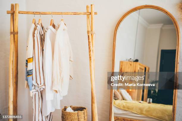 clothes hanging on a hangers near a mirror at  home. - shabby chic stock pictures, royalty-free photos & images