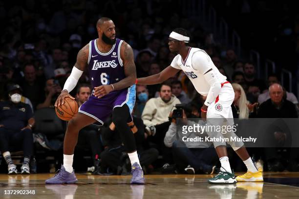 LeBron James of the Los Angeles Lakers handles the ball against Reggie Jackson of the Los Angeles Clippers during the third quarter at Crypto.com...
