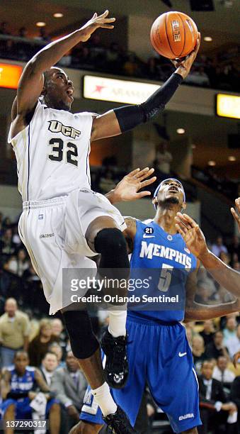 Central Florida's Isaiah Sykes leaps over Memphis' Will Barton at the UCF Arena in Orlando, Florida, on Wednesday, January 18, 2012.