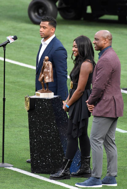 Russell Wilson of the Seattle Seahawks, Brittney Payton and Jarrett Payton daughter and son of the late Hall of Famer Walter Payton stands with the...