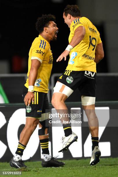 Ardie Savea of the Hurricanes celebrates after scoring a try with Devan Flanders during the round two Super Rugby Pacific match between the Blues and...