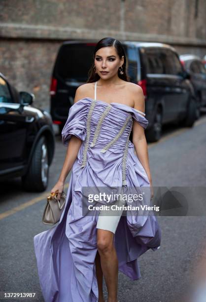 Karina Nigay seen wearing pink off shoulder dress, grey bag, heels outside Sportmax fashion show during the Milan Fashion Week Fall/Winter 2022/2023...