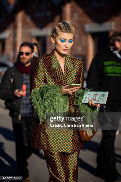 Amalie Gassmann seen wearing brown suit with print, Gucci bag outside Gucci fashion show during the Milan Fashion Week Fall/Winter 2022/2023 on...