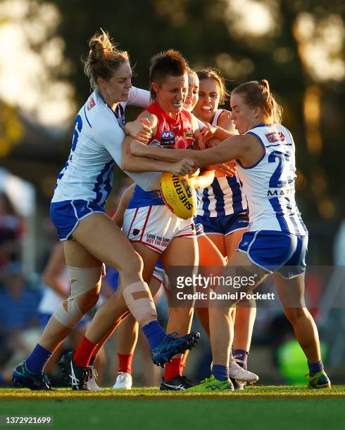 Karen Paxman of the Demons is gang-tackled by Kangaroos players during the round eight AFLW match between the Melbourne Demons and the North...