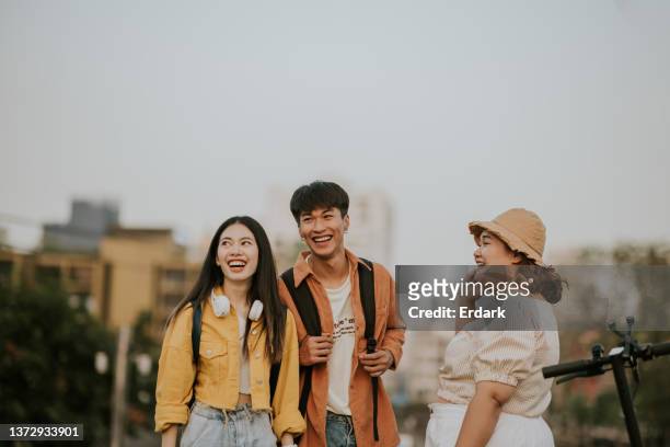 group of friends are talking and laughing together. - asia friend stock pictures, royalty-free photos & images