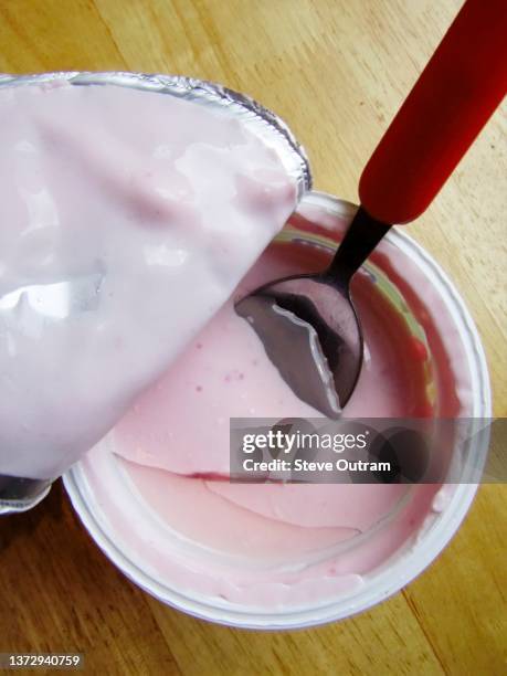 a carton of strawberry flavor greek yogurt - joghurtbecher stock-fotos und bilder