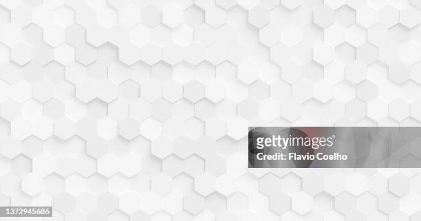 white wall with subtle white hexagon pattern - hexagon pattern stock pictures, royalty-free photos & images