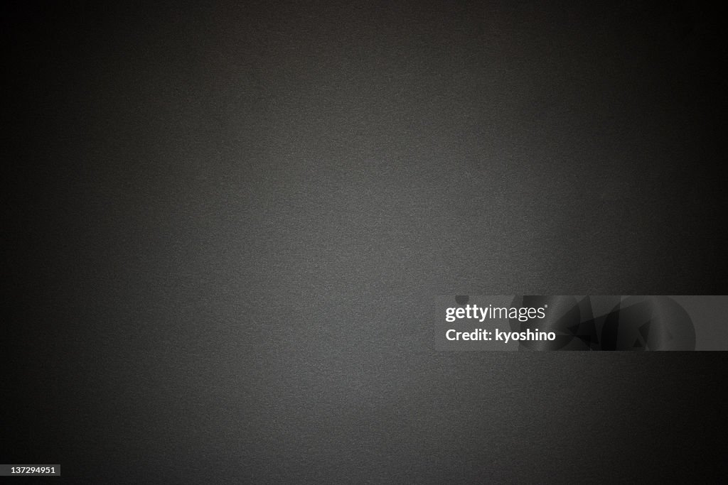 Black paper texture background with spotlight