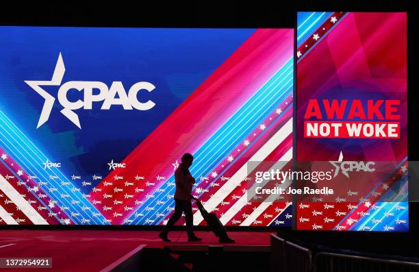 Worker vacuums the stage at the Conservative Political Action Conference at The Rosen Shingle Creek on February 26, 2022 in Orlando, Florida. Former...