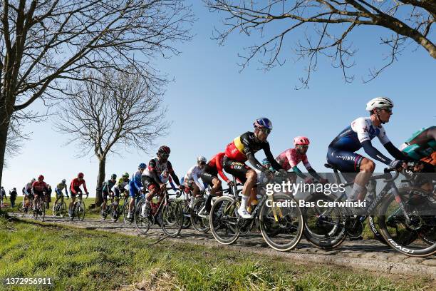 Wout Van Aert of Belgium and Team Jumbo - Visma, Yves Lampaert of Belgium and Team Quick-Step - Alpha Vinyl and The Peloton compete during the 77th...