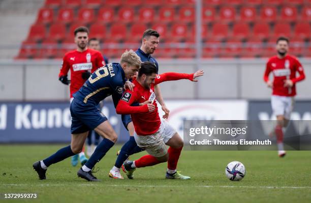 Dominic Baumann of Zwickau in action with Leandro Morgalla of 1860 München during the 3. Liga match between FSV Zwickau and TSV 1860 München at...