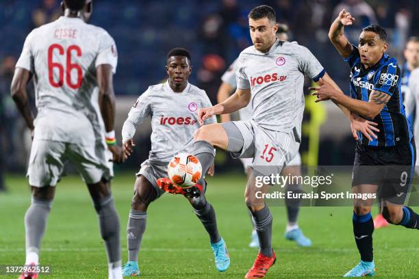 Sokratis Papastathopoulos of Olympiacos looks to pass the ball during the UEFA Europa League Knockout Round Play-Offs Leg One match between Atalanta...