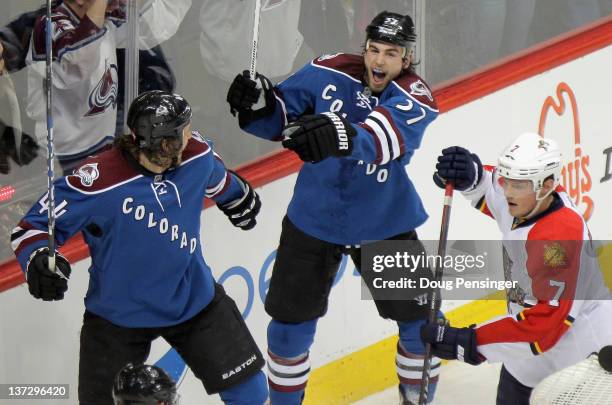 Ryan O'Reilly of the Colorado Avalanche celebrates his game winning goal in overtime with teammate Ryan Wilson of the Colorado Avalanche as Dmitry...