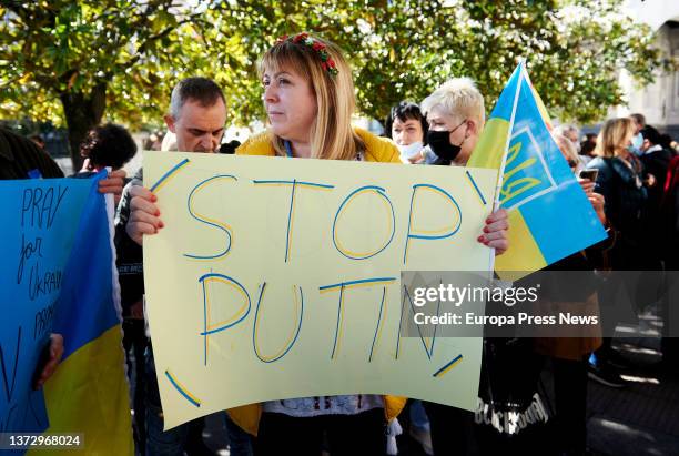 Woman, with a banner reading 'Stop Putin', demonstrates against the war, in front of the Government Delegation in Santander, on 26 February, 2022 in...