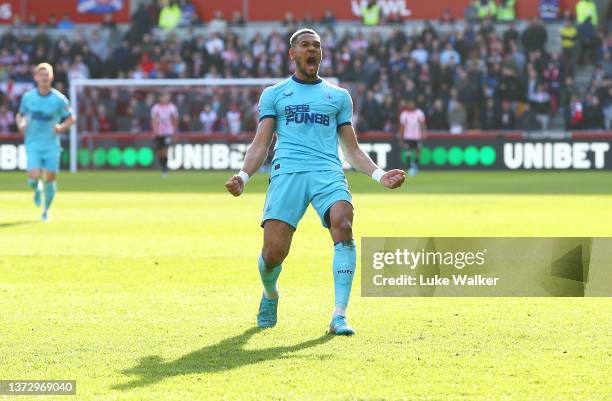 Joelinton of Newcastle United celebrates after scoring their team's first goal during the Premier League match between Brentford and Newcastle United...