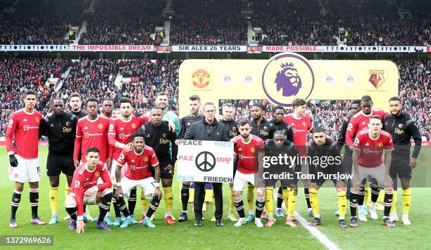 Both teams pose behind a sign reading Peace in several languages ahead of the Premier League match between Manchester United and Watford at Old...