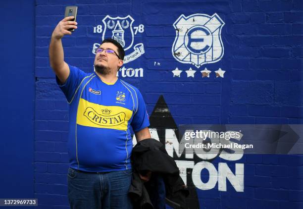 Fan wearing a Vina Del Mar shirt takes a selfie outside the stadium prior to the Premier League match between Everton and Manchester City at Goodison...