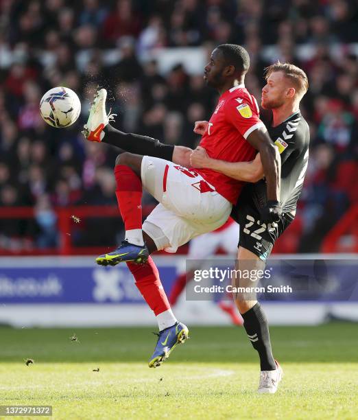 Keinan Davis of Nottingham Forest is challenged by Tomas Kalas of Bristol City during the Sky Bet Championship match between Nottingham Forest and...