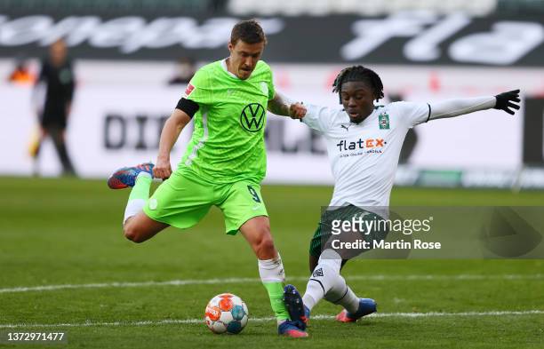 Wout Weghorst of VfL Wolfsburg is challenged by Kouadio Kone of Borussia Monchengladbach during the Bundesliga match between Borussia Mönchengladbach...