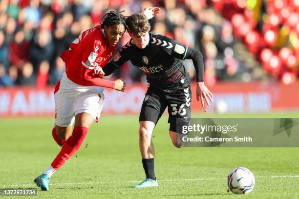 Djed Spence of Nottingham Forest battle for possession with Alex Scott of Bristol City during the Sky Bet Championship match between Nottingham...