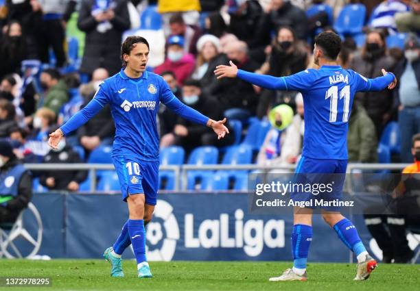 Enes Unal of Getafe CF celebrates with his teammate Carles Alena of Getafe CF after scoring the opening goal during during the LaLiga Santander match...