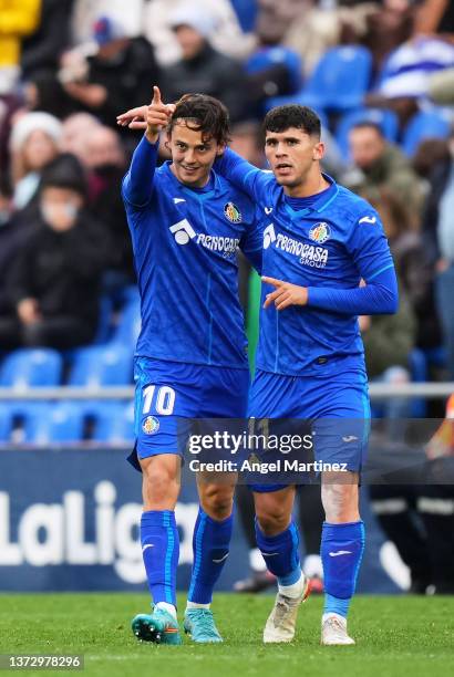 Enes Unal of Getafe CF celebrates with his teammate Carles Alena of Getafe CF after scoring the opening goal during during the LaLiga Santander match...