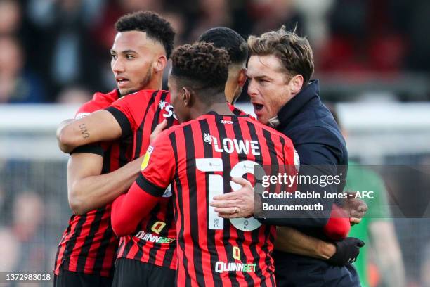 Head Coach Scott Parker of Bournemouth celebrates with Lloyd Kelly and goal-scorers Dominic Solanke and Jamal Lowe after their sides 2-1 win during...