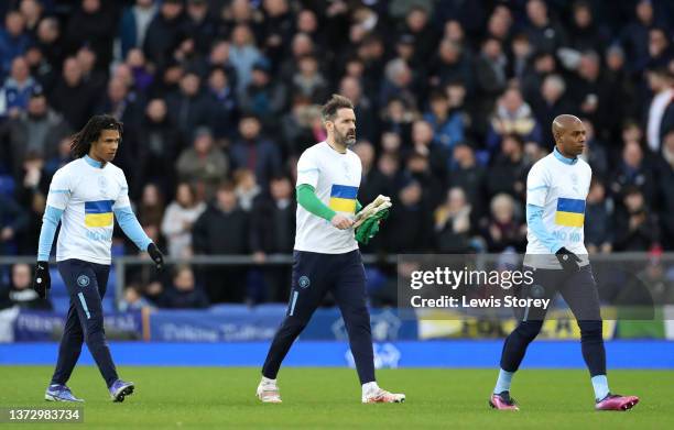 Nathan Ake, Scott Carson and Fernandinho of Manchester City wear shirts containing the Ukrainian flag to indicate peace and sympathy with Ukraine...