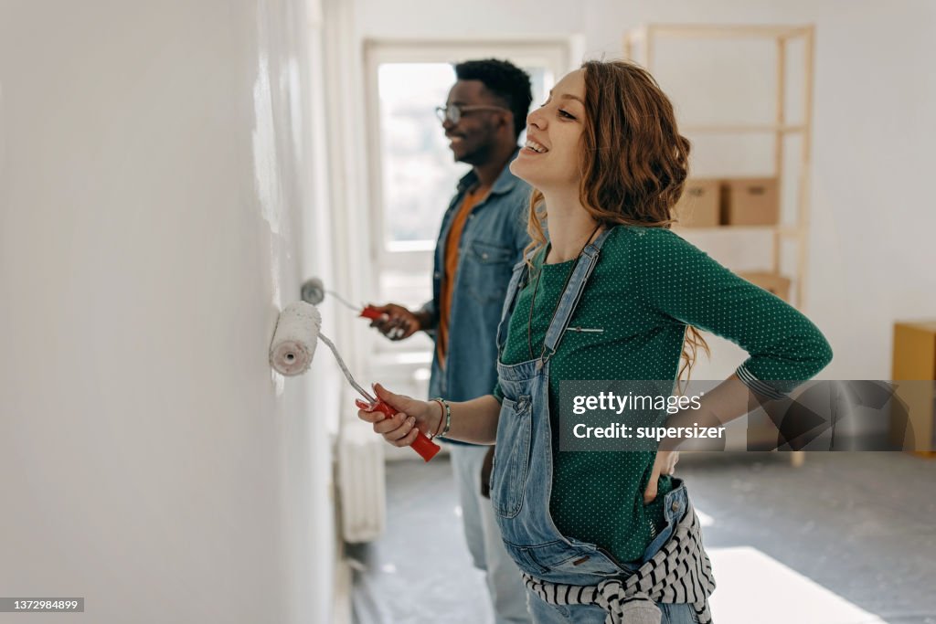 Young couple painting walls