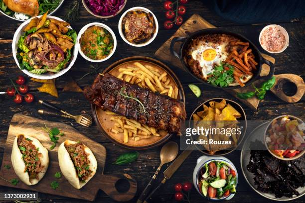 various dishes and snacks. table top view. - american food stock pictures, royalty-free photos & images