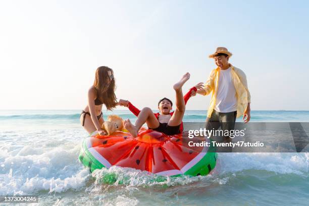 asian family playing on the beach - tourist mother father child thailand stock pictures, royalty-free photos & images