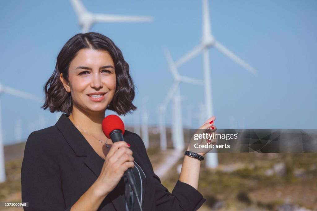 TV news reporter woman making reportage about a renewable energy