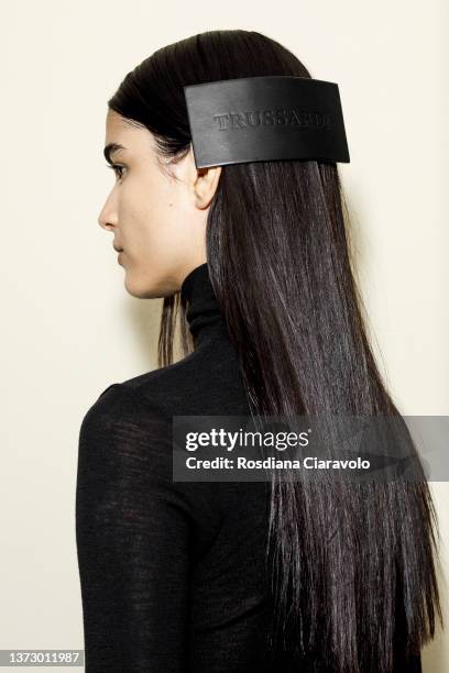 Model, hair detail, poses backstage of the Trussardi fashion show during the Milan Fashion Week Fall/Winter 2022/2023 on February 26, 2022 in Milan,...