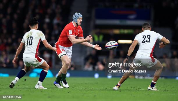 Jonathan Davies of Wales is watched by Marcus Smith during the Guinness Six Nations Rugby match between England and Wales at Twickenham Stadium on...