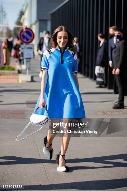 Guest is seen wearing blue dress outside Gucci fashion show during the Milan Fashion Week Fall/Winter 2022/2023 on February 25, 2022 in Milan, Italy.