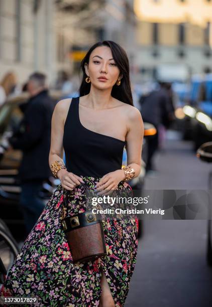 Jessica Wang seen wearing black ripped off top, skirt with slit & floral print, brown bag outside Etro fashion show during the Milan Fashion Week...