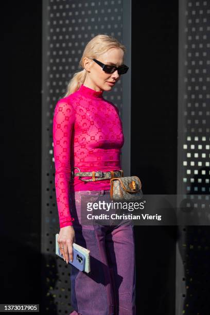 Olga Karput is seen wearing pink top, purple pants, Gucci bag outside Gucci fashion show during the Milan Fashion Week Fall/Winter 2022/2023 on...