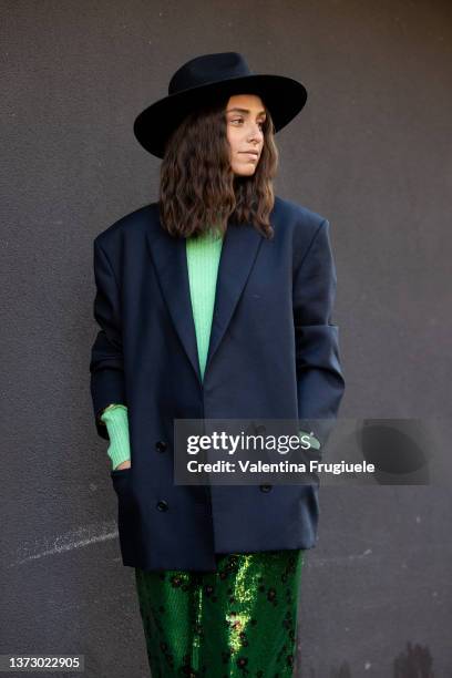 Erika Boldrin poses ahead of the Philosophy fashion show wearing green sequin leopard pants and felt ha during the Milan Fashion Week Fall/Winter...