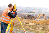 Land surveyor on construction site