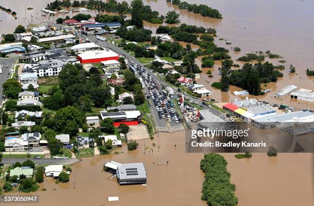 In an aerial view, vehicles are seen stuck along a street as floodwaters surround Gympie on February 27, 2022 in an area north of Sunshine Coast,...
