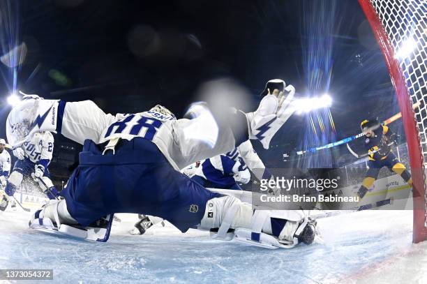 Filip Forsberg of the Nashville Predators shoots the puck toward the net as goaltender Andrei Vasilevskiy of the Tampa Bay Lightning reaches out with...