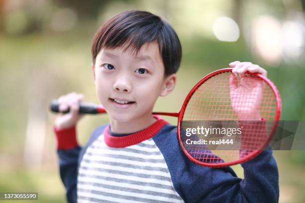 a little boy playing badminton - fjäderboll bildbanksfoton och bilder