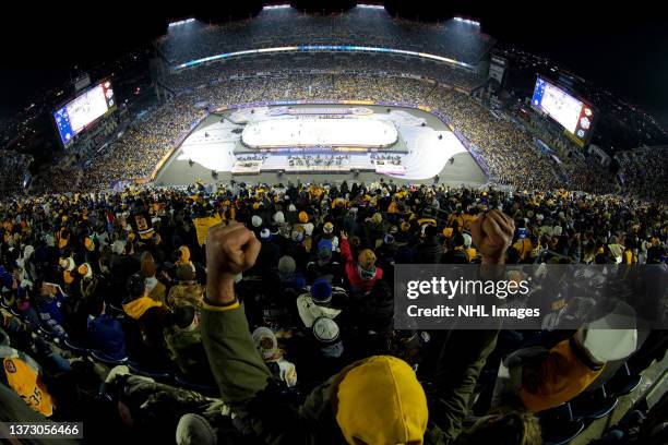 Fan raises his arms and cheers on during the 2022 NHL Stadium Series game between the Tampa Bay Lightning and the Nashville Predators at Nissan...