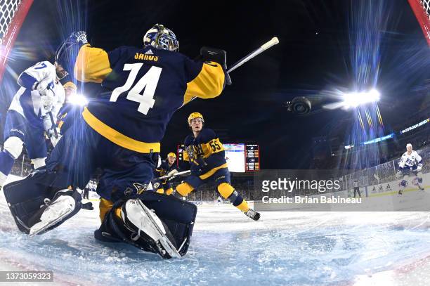 Steven Stamkos of the Tampa Bay Lightning watches the puck go past goaltender Juuse Saros of the Nashville Predators and toward the net for a goal...