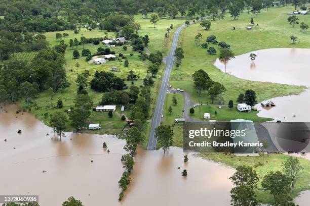 In an aerial view, roads that lead into Gympie are surrounded by floodwaters on February 27, 2022 in an area north of Sunshine Coast, Australia....