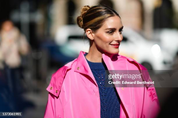 Olivia Palermo wears a navy blue braided wool pullover, a pink oversized short sleeves coat from Ermanno Scervino, outside the Ermanno Scervino...