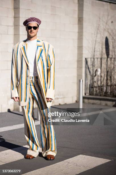 Guido Milani poses ahead of the Marni fashion show wearing black sunglasses and a beige, yellow and bue suit during the Milan Fashion Week...